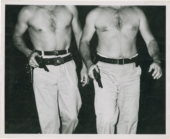 Weegee.
[Two police officers who dove into Hudson River to save Donna Landon, New York], July 20, 1941. 
© Weegee/International Center of Photography/Getty Images