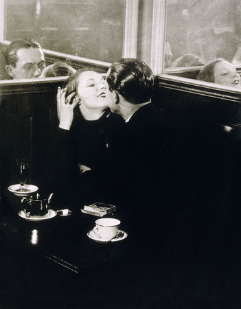 Brassai.
Pair of lovers in a small Paris cafe, place d’Italie 
about 1932.
Brassai loved the Paris of thugs, prostitutes, cabarets and unexpected encounters. The city of bars where lovers linger. He has slicked-back hair. She is smiling and in love. The mirror replicates their passionate fervour. 
The Hungarian Brassai arrived in Paris in 1924. A humanist photographer of genius, he was the first to pursue the secret and poetic world of Paris by Night, as seen in his famous book published in 1932.
Modern еxhibition print.
Brassai Estate, Paris.
BRASSAI © Estate Brassai / dist. RMN