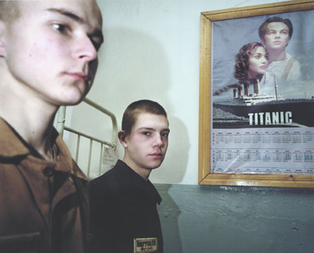 Carl De Keyzer.
Youth camp. Kansk. 14—18 year old boys. Dormitory wall decorated with Di Caprio “Titanic” poster. 
2000. 
Project “Zona”. Prison camps. Former Gulags.
Russia. Siberia. Krasnojarsk region. 
© Carl De Keyzer / Magnum Photos