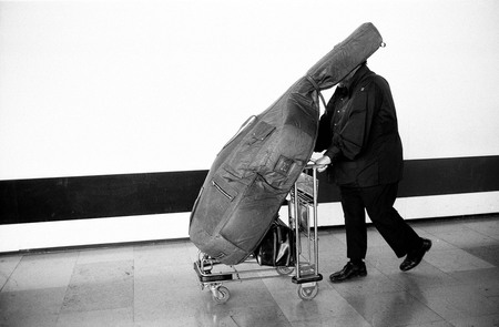 Guy Le Querrec.
Bouches-du-Rhone department. 
August 19, 1976. 
The American jazz musician Charles MINGUS (bass player), leaving Marseille-Marignane’s airport, the day after the concert of the CHARLIE MINGUS QUARTET in Chateauvallon. The quartet includes the American jazz musicians: Ricky FORD (saxophone), Jack W. 
© Guy Le Querrec / Magnum Photos