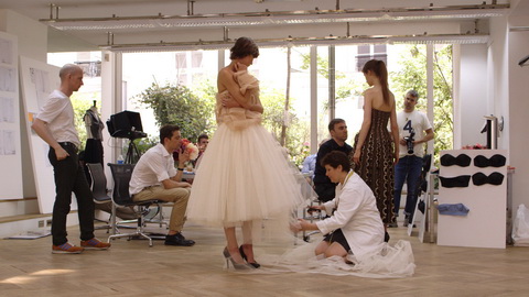 Raf Simons works on his reinterpretation of a Dior dress. Credit: CIM Productions