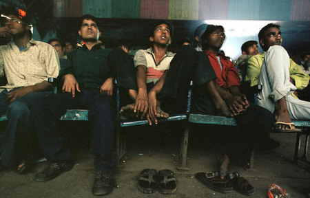 Jonathan Torgovnik.
The front row of New Shirin Cinema in Mumbai (Bombay), while the film is projected. The cinema is divided to sections and ticket price. The people which sit in the front rows are considered the biggest fans. 
2002. 
Presented by Admira, Milan