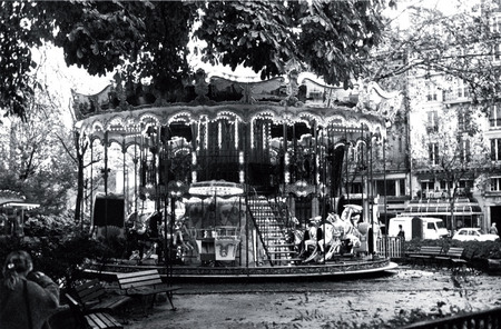 Bernard Plossu.
Merry-go-round. 
1985. 
This artist, who was born in Vietnam and lived in the south of France, was one day passing the Place du Chatelet, opposite the Ile de la Cite. In the square, there was a merry-go-round. The light bulbs shone. 
He took photographs. “In photography, he says, one does not capture time, one evokes it. It flows like endless fine sand and the changing landscapes change nothing”.
© Bernard Plossu