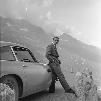 Sean Connery relaxes on the bumper of his Aston Martin DB5 during the filming of location scenes for 'Goldfinger' in the Swiss Alps.
Copyright Notice - © 1964 Danjaq, LLC and United Artists Corporation. All rights reserved